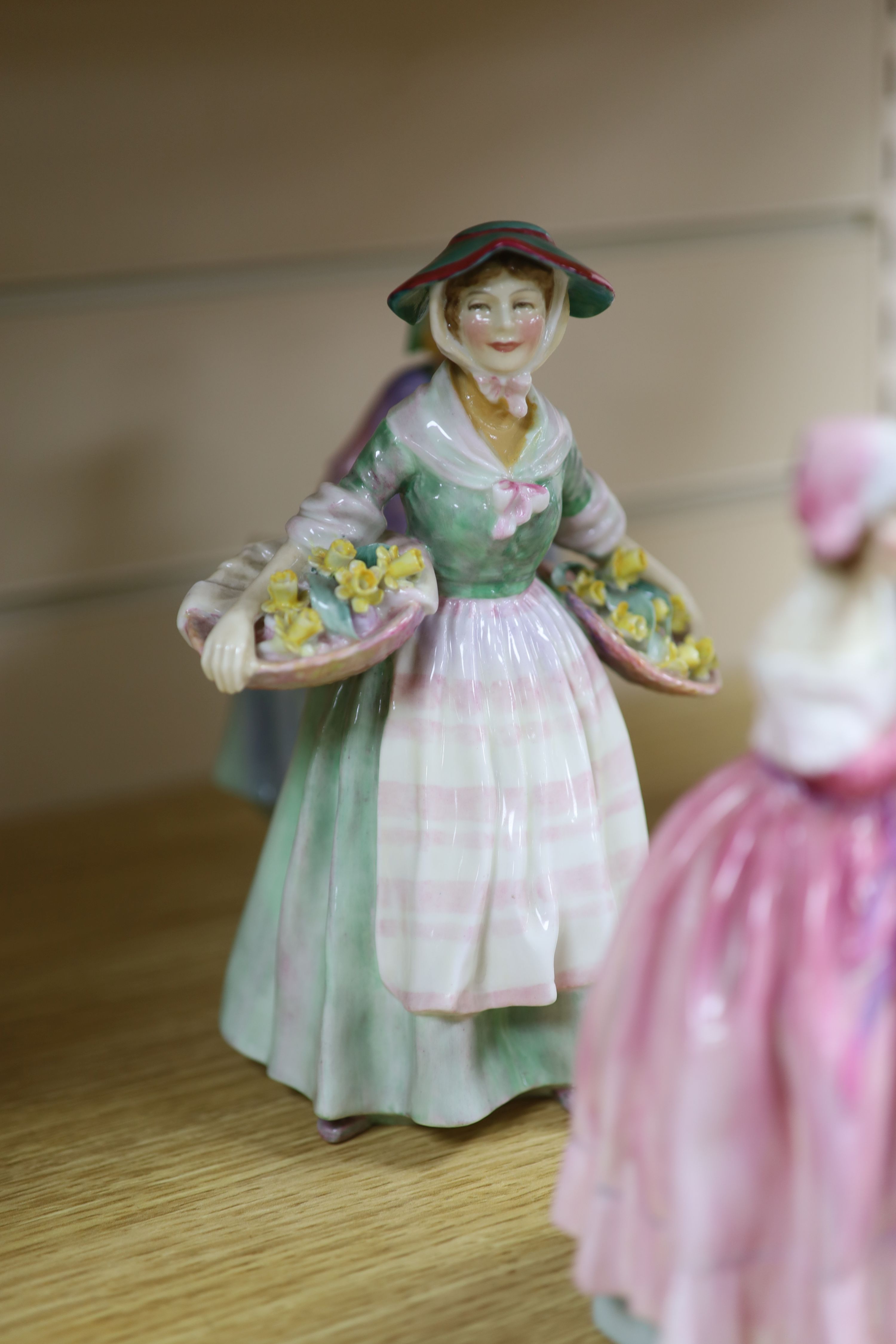 A collection of seven Royal Doulton figures: Priscilla HN1340, Daffy Down Dilly HN1712, The New Bonnet HN1728, Greta HN1485,